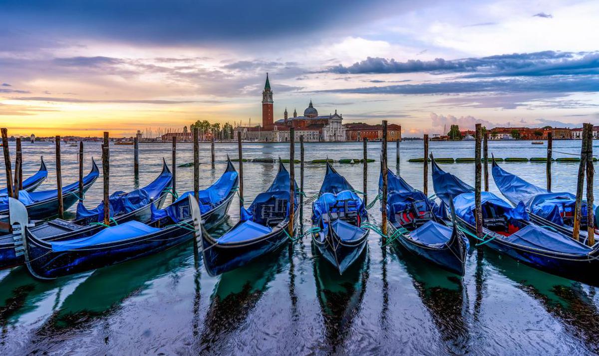 Image of Gondola, Water transportation, Boat, Reflection, Waterway, Sky etc.